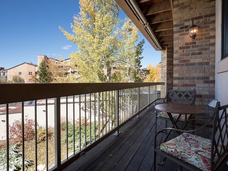 Picture yourself sipping morning coffee on your private balcony, surrounded by golden autumn foliage and fresh air. This cozy outdoor retreat offers peaceful neighborhood views and a perfect spot to unwind after exploring.