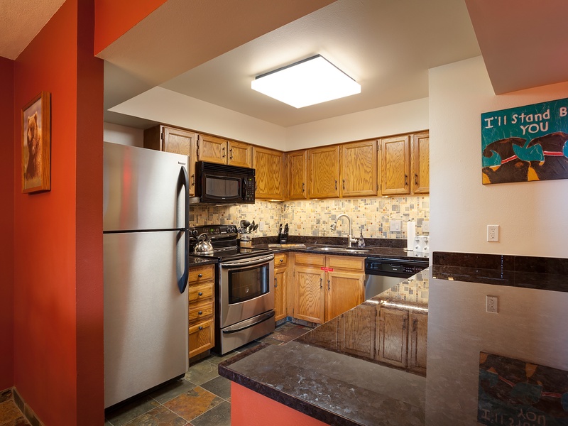 Your fully-equipped kitchen has everything you need to prepare your favorite meals, with warm wood cabinetry, modern appliances, and plenty of counter space for easy cooking.
