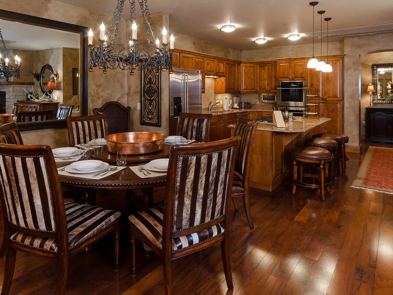 Your elegant dining space and fully equipped kitchen invite memorable meals together. Warm wood tones, custom cabinetry, and gleaming appliances blend comfort with style—your home away from home.