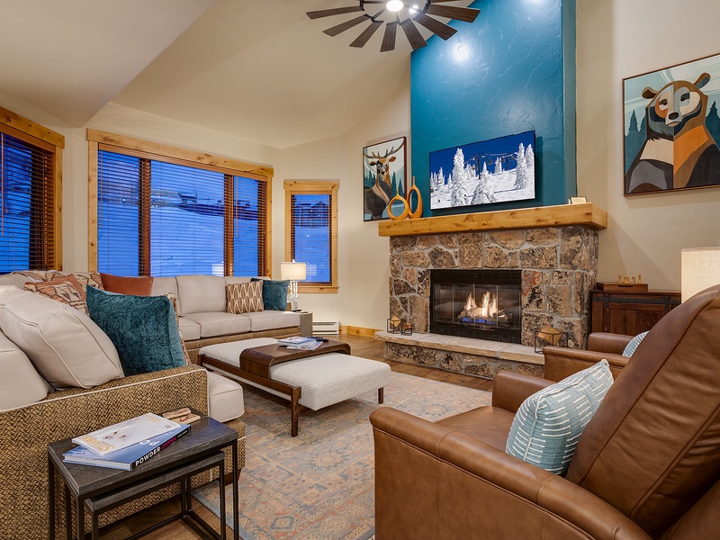 Settle into this inviting living room where your mountain retreat begins. Sink into plush seating by the stone fireplace, perfect for unwinding after your adventures on the slopes.