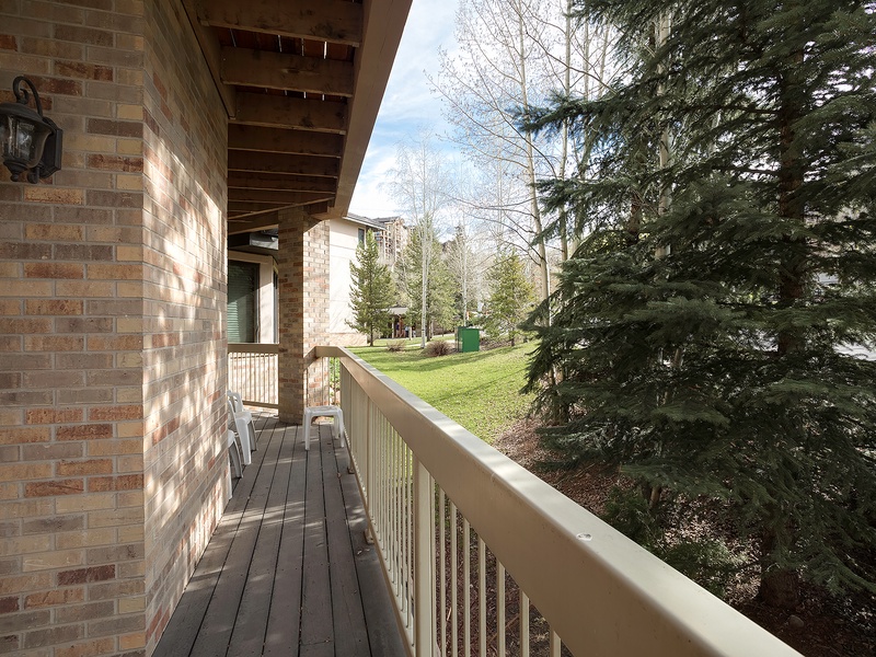 The property features a peaceful setting surrounded by mature evergreens and natural landscaping, offering a serene backdrop for your mountain getaway.