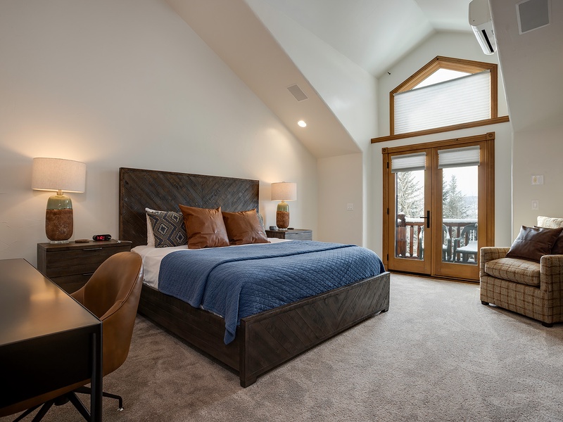 Wake up to snowy treetops framed by the door to your private balcony. This spacious retreat features vaulted ceilings, a cozy reading chair, and a plush king bed calling your name.