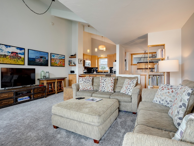 Sink into plush sofas and unwind in your open-concept living space, where natural light, warm wood accents, and modern comforts create the perfect retreat after a day of adventure.
