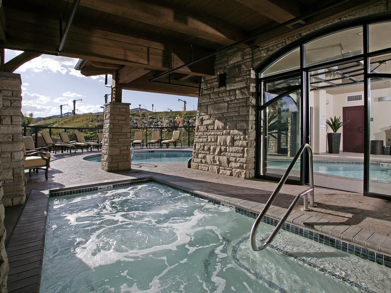 Multiple hot tubs and a pool offer the perfect setting to unwind and soak your cares away, all under a rustic covered patio with mountain views.