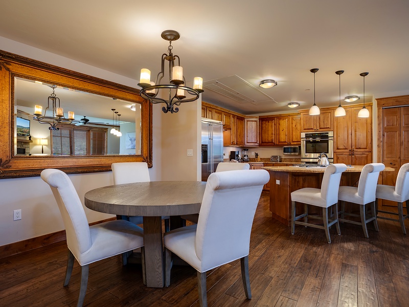 Gather around the spacious dining area and fully equipped kitchen, where warm wood tones and elegant finishes create the perfect setting for your group meals and morning coffee.