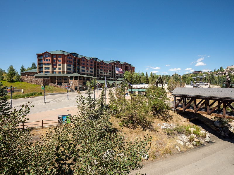 This property sits in a scenic mountain village setting surrounded by evergreen forests and winding pathways, perfect for a peaceful alpine getaway.