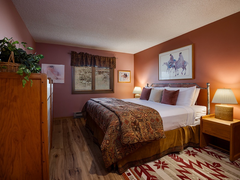 Sink into your plush bed surrounded by warm earth tones and western charm. Soft lighting, tasteful artwork, and cozy textures create a peaceful retreat after your adventures.