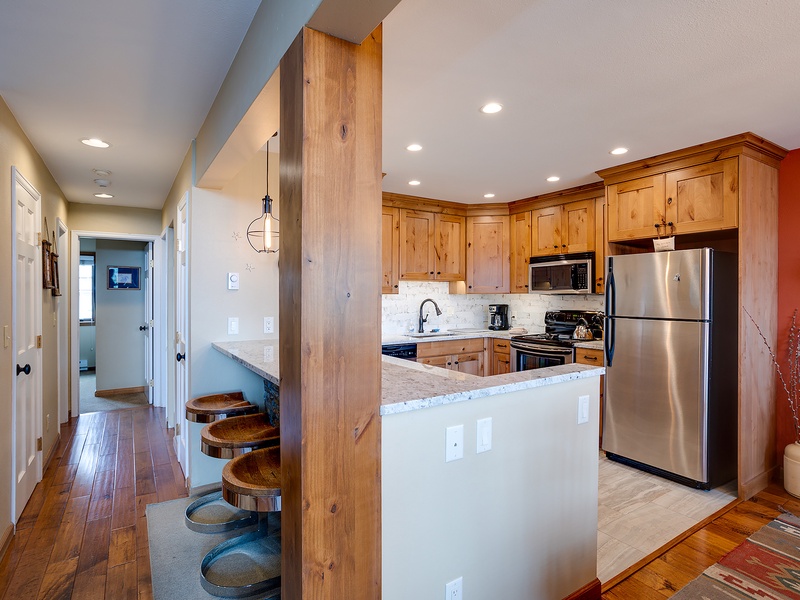 Your bright, fully equipped kitchen features stainless steel appliances, elegant granite countertops, and a breakfast bar perfect for casual dining or morning coffee with loved ones.