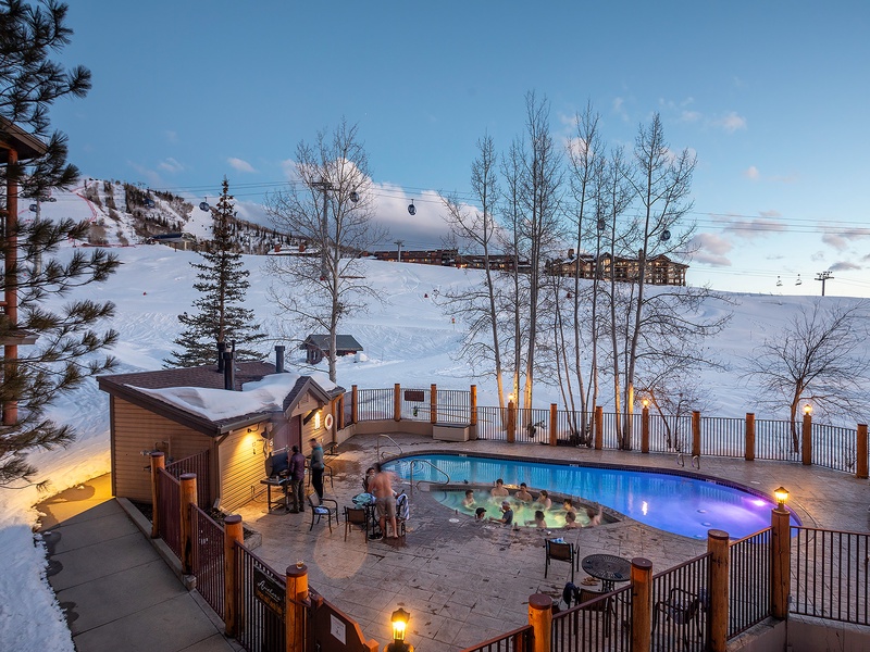 A heated outdoor pool nestled slopeside, where winter evenings turn magical. Watch the sunset paint the snow while you soak under twinkling lights, surrounded by ski runs and mountain views.