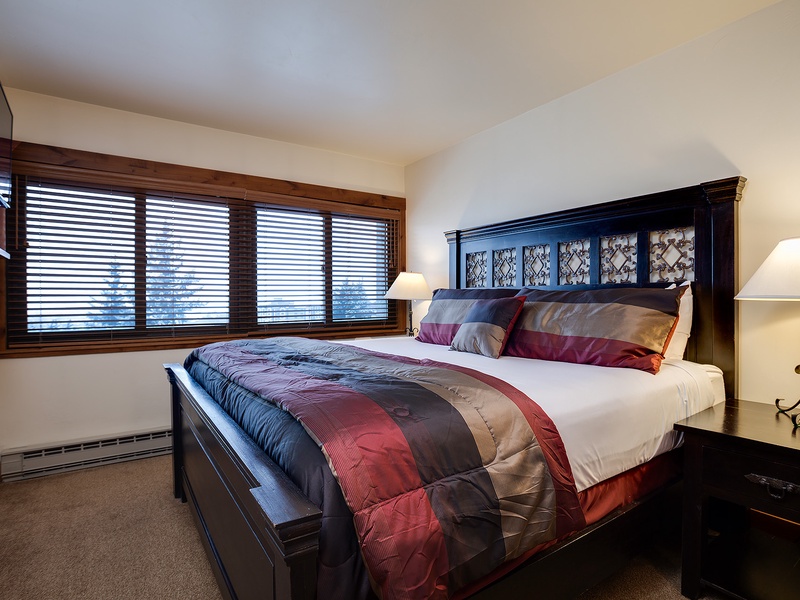Sink into plush bedding and wake to soft natural light filtering through your private window. Your restful retreat features elegant furniture and warm bedside lamps creating the perfect atmosphere for relaxation.