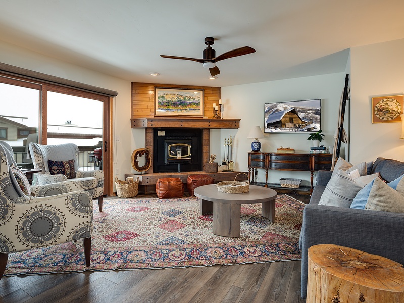 Curl up in your cozy living room with a warm fireplace, plush seating, and rustic mountain charm that makes every evening feel like home.
