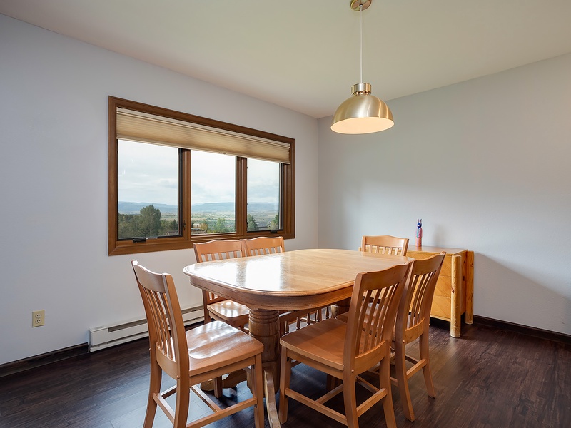 Gather around this inviting table and enjoy meals with stunning mountain views as your backdrop. The bright, airy space creates the perfect setting for memorable conversations.