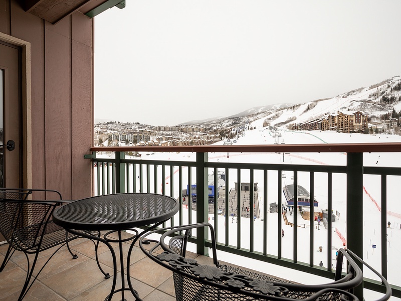 A private balcony overlooks pristine ski slopes and snow-dusted mountain terrain, offering direct views of winter adventures awaiting just beyond your cozy retreat.