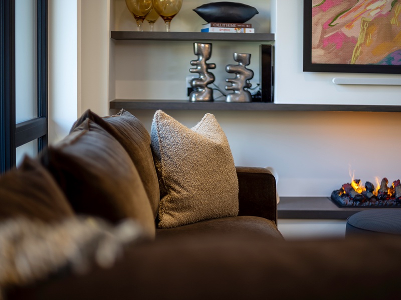 Sink into plush seating beside a warming fireplace and admire the curated art and sculpture that make this space feel like your own stylish retreat.