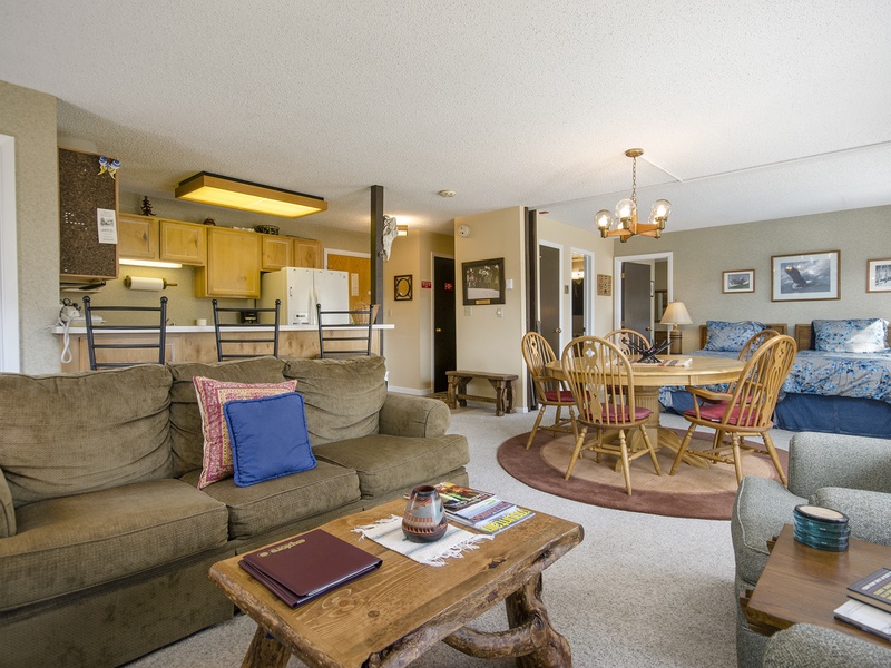 Step into your cozy open-concept retreat where rustic charm meets home comfort. Relax on plush sofas, gather around the dining table, and unwind in your inviting sleeping area—all seamlessly connected for easy living.