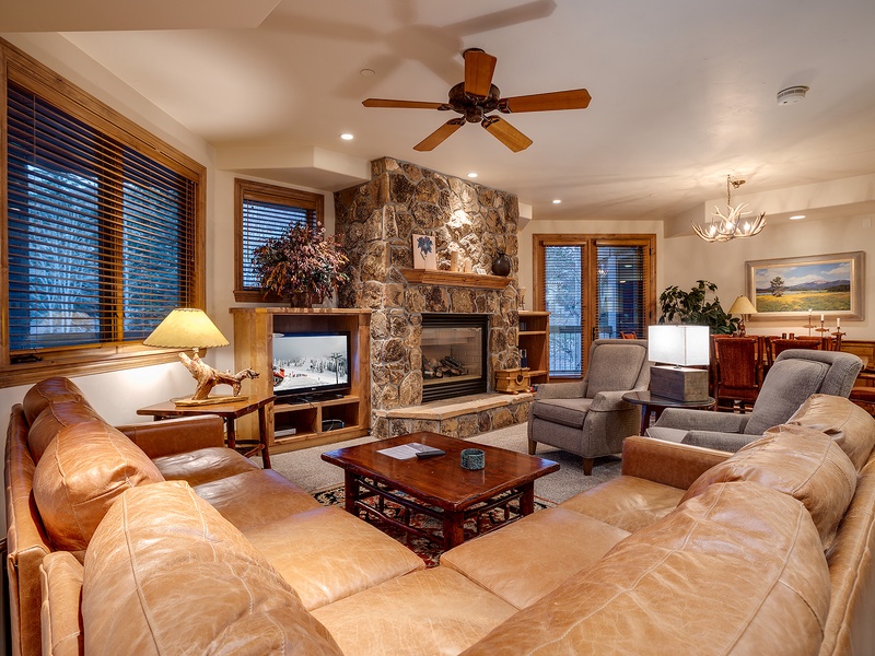 Sink into plush leather sofas, feel the warmth of your stone fireplace, and unwind in this inviting living space designed for your comfort and relaxation.