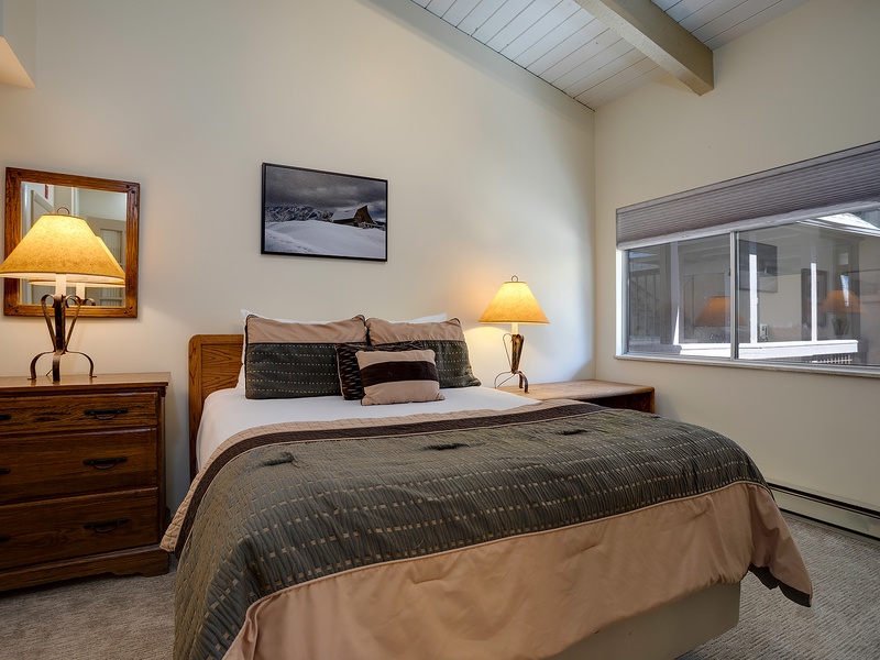 Sink into your plush bed as warm lamplight glows, creating a peaceful retreat where you can unwind under exposed beam ceilings after a day exploring the mountains.