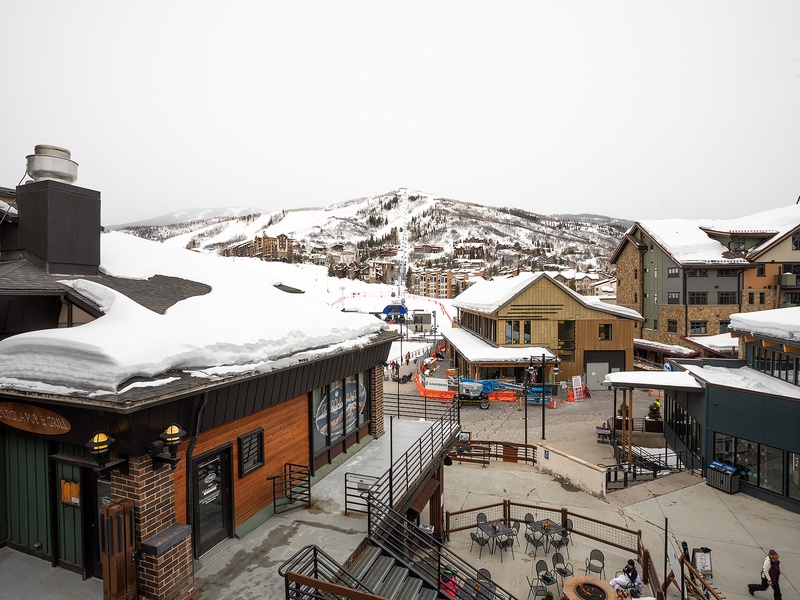 A picturesque alpine village nestled in the mountains, featuring ski slopes, lodges, and shops blanketed in winter snow—the gateway to adventure.
