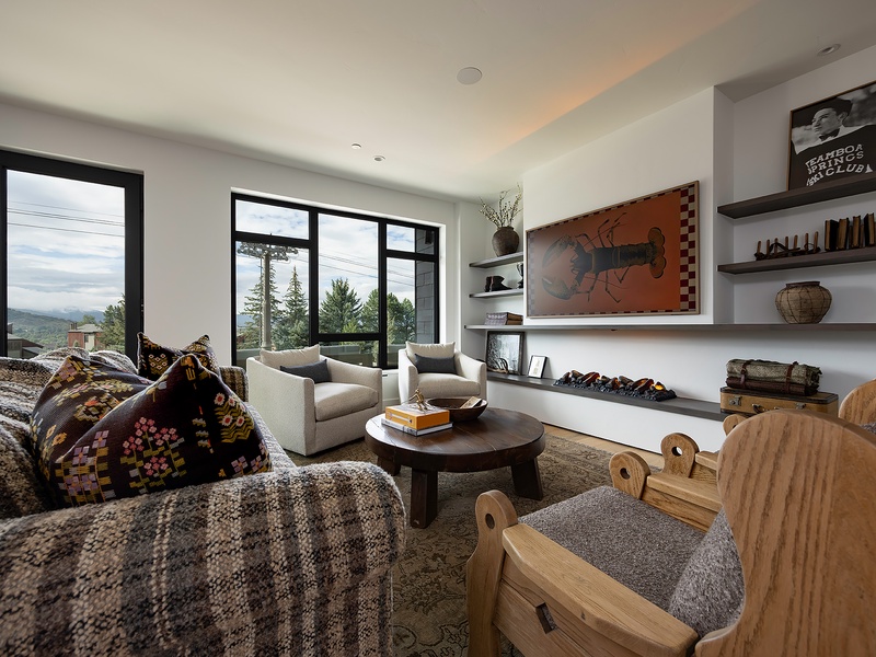Sink into your private living area and enjoy mountain views through expansive windows. Warm textures, curated art, and thoughtful design create your perfect retreat.