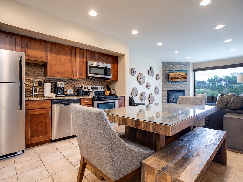Your open-concept kitchen and living space welcomes you with warm wood tones, granite counters, stainless appliances, and scenic views perfect for relaxing after exploring the area.
