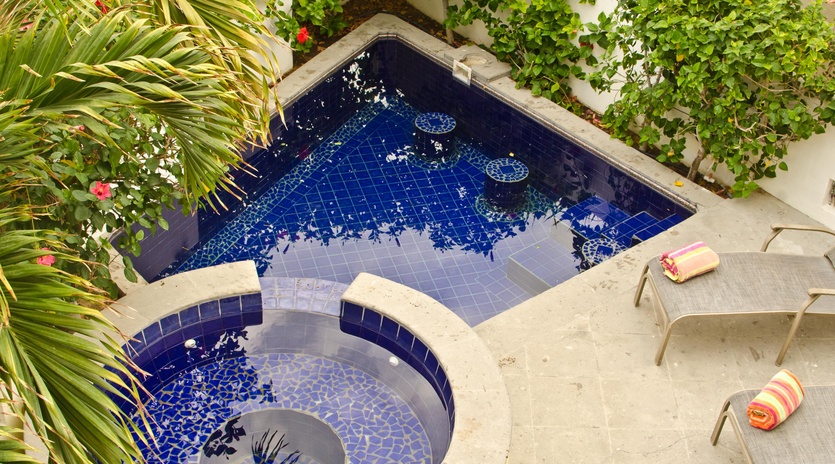 Patio with lounge chairs, pool and jacuzzi