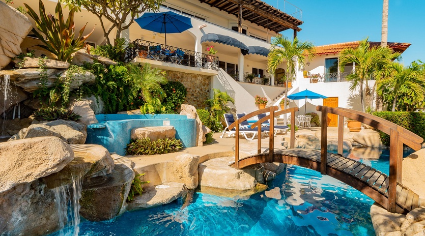 Patio with infinity pool and walkway bridge