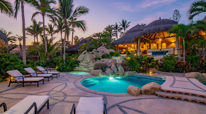 Poolside view of patio during sunset