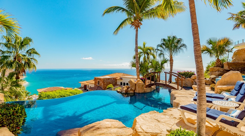 Patio with infinity edge pool and ocean view