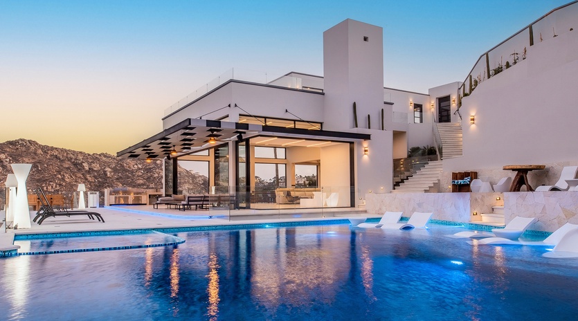 Poolside view of villa during sunset