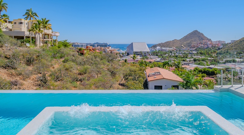 Soak in stunning coastal views while relaxing in your private hot tub overlooking the sparkling sea and mountains.