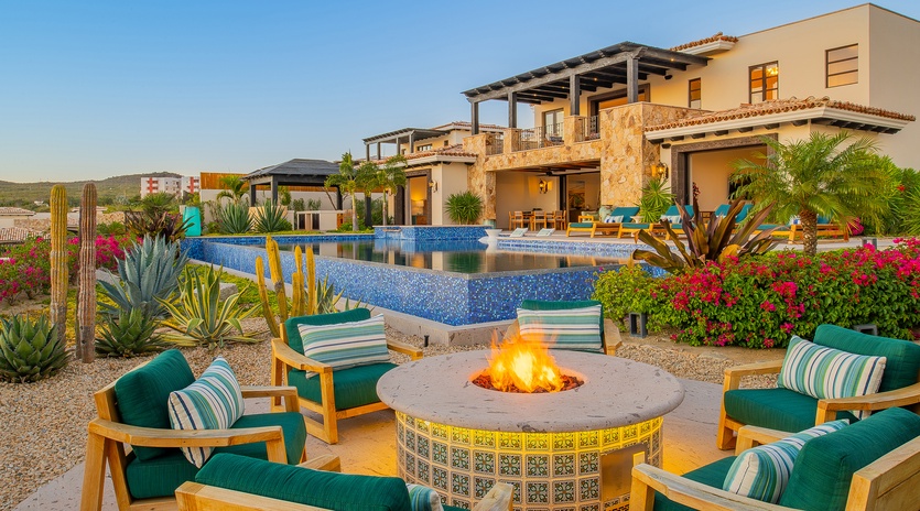 Stunning villa with desert fire pit and infinity pool creates the perfect evening retreat in tropical paradise.