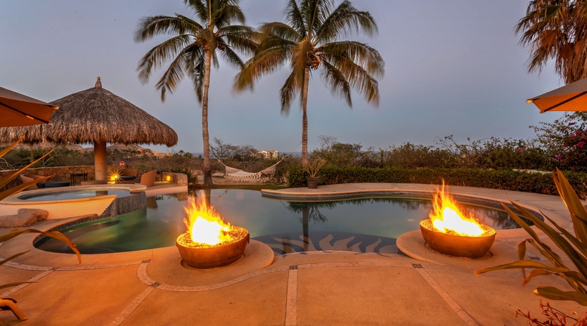 Patio with pool, jacuzzi, and fire pits