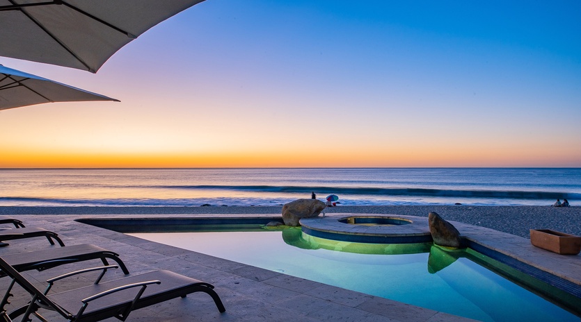 Incredible beachfront patio with pool and jacuzzi during sunset