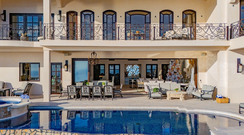 Poolside view of patio and villa exterior