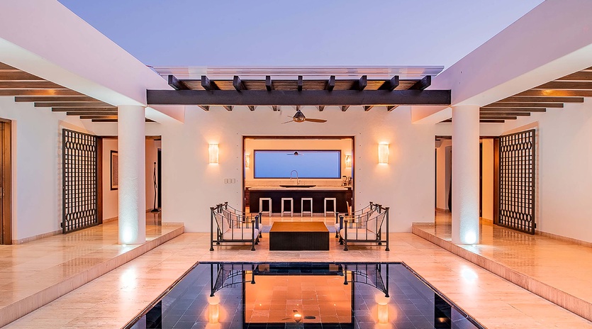 Your private oasis awaits with an elegant indoor pool, stylish lounge seating, and stunning open-air design that brings the evening sky right to you.