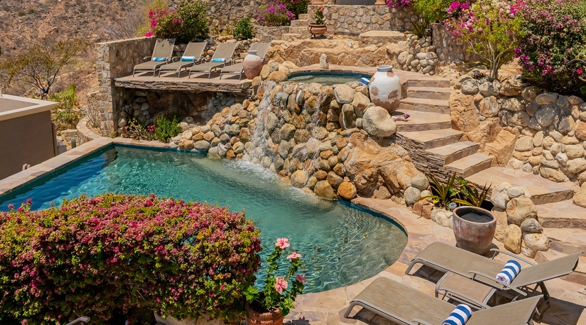 Stone patio with sun deck and pool