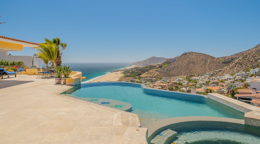 Stunning infinity pool with panoramic ocean and mountain views creating the perfect backdrop for your vacation relaxation.
