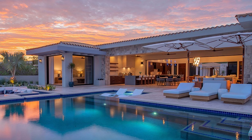 Stunning sunset views frame this luxurious property, where your private pool beckons under painted skies. Sink into poolside loungers as twilight hues dance across the water, casting a warm glow over your open-air retreat.