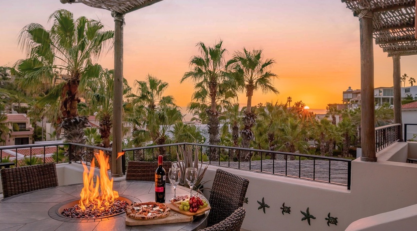 Outdoor dining with firepit over looking a gorgeous sunset view
