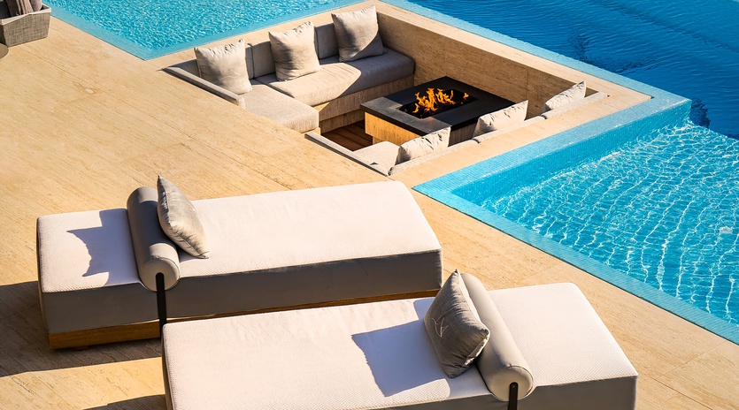Patio with infinity pool and built-in seating area
