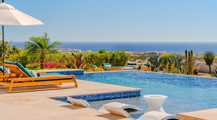Dive into paradise at your private pool with sweeping sea views and desert garden backdrop.