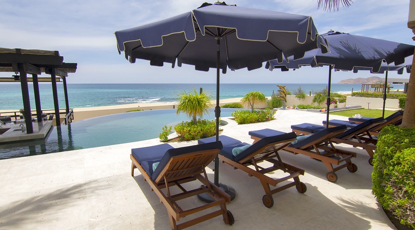 Lounge poolside with a beachfront view