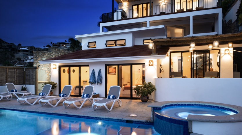 Modern villa with pool and hot tub creates perfect evening ambiance for relaxation under the stars.
