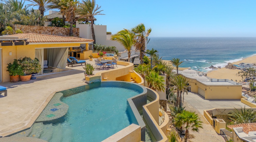 Stunning beachfront villa with infinity pool overlooking pristine coastline and tropical gardens.