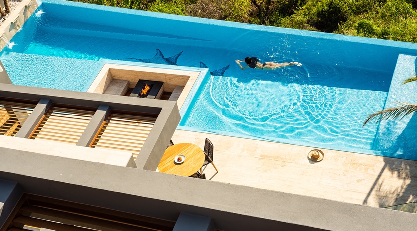 Sunny patio with infinity pool and ocean view