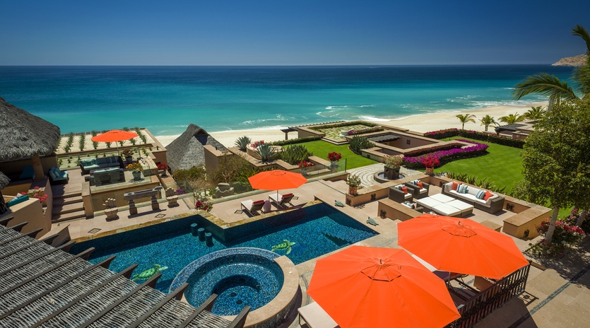Stunning beachfront villa featuring pool, spa, and pristine beach access with vibrant tropical gardens and ocean views.