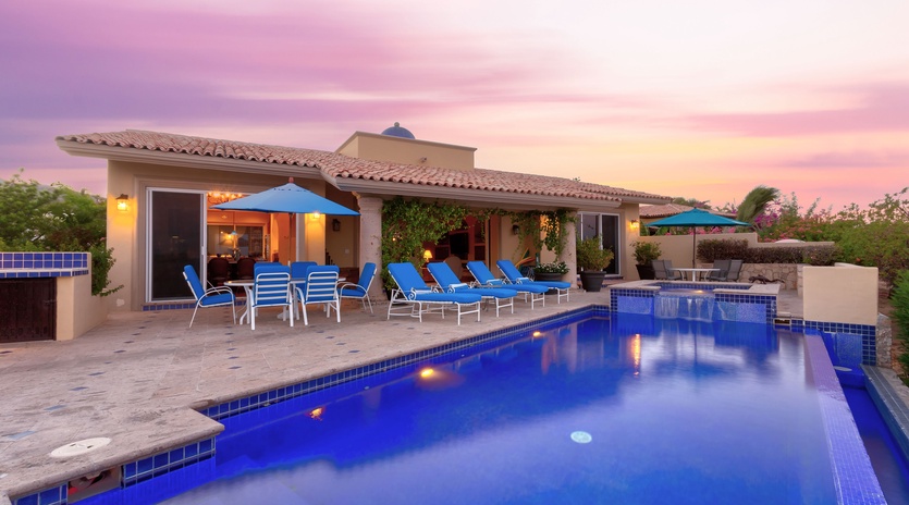 Poolside view of villa during sunset
