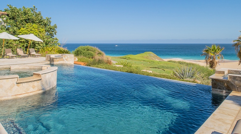 Infinity pool with ocean and beach view