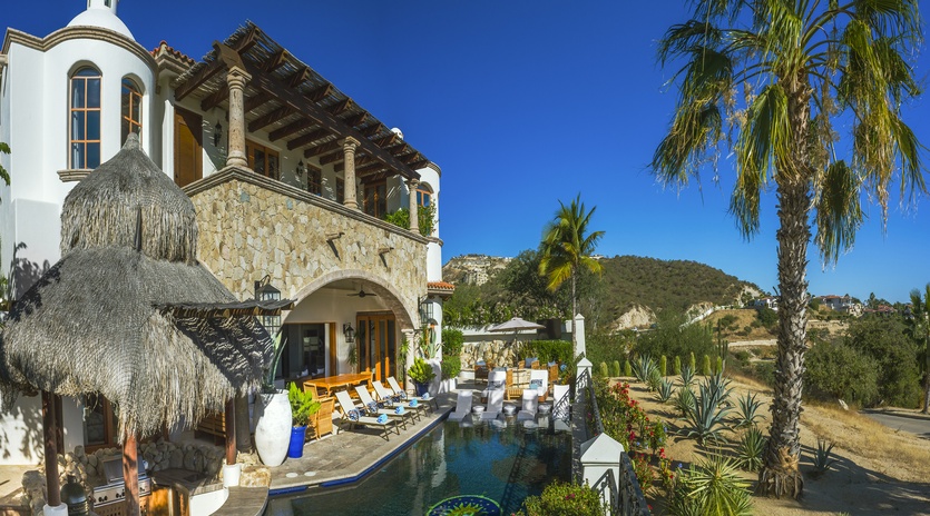 Stunning Mexican villa with private pool, tropical palapa, and mountain backdrop creates your perfect desert oasis retreat.