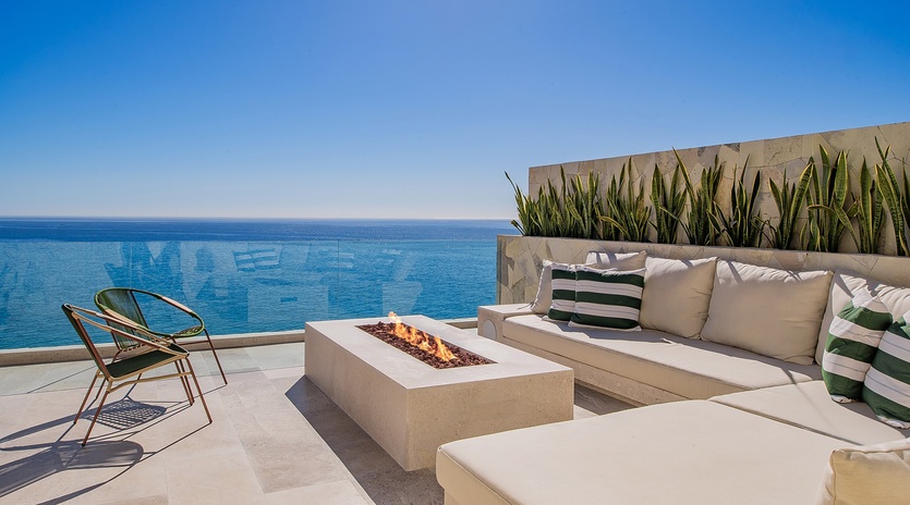 Sunny patio with outdoor seating and fireplace